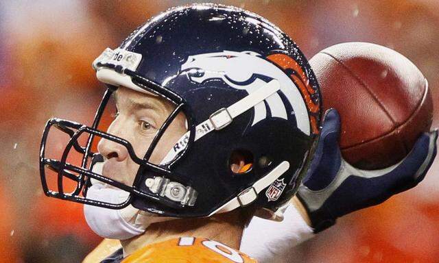 Denver Broncos' Manning passes in rain against Baltimore Ravens during NFL football game in Denve