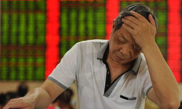 FUYANG CHINA JULY 02 CHINA OUT An investor reacts in front of an electronic board at a stock e