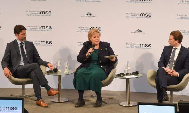 Justin Trudeau und Sebastian Kurz nehmen Erna Solberg, die norwegische Ministerpräsidentin, bei einer Podiumsdiskussion in München in die Mitte.