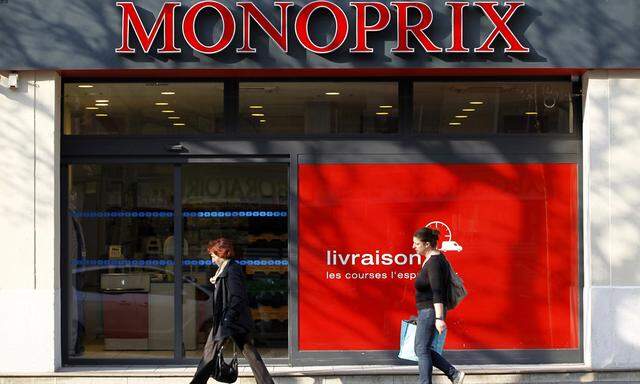 People walk past a Monoprix food and fashion store in Vincennes