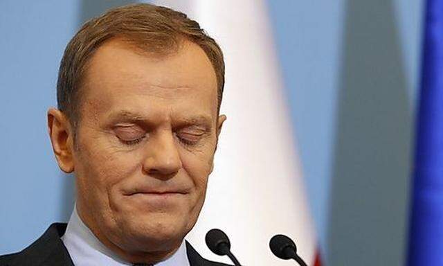 Polands PM Tusk pauses during a news conference at the PMs Chancellery in Warsaw