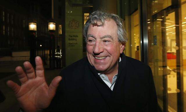 British comedian Jones smiles as he leaves The Rolls Building in central London