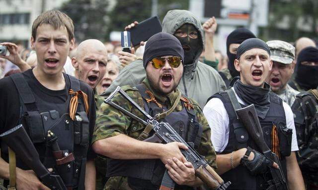 Armed pro-Russian separatists of the self-proclaimed Donetsk People's Republic pledge an oath during ceremony in the city of Donetsk