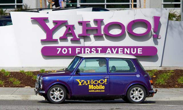 A man drives a Mini Cooper with a Yahoo! logo in front of Yahoo! headquarters in Sunnyval