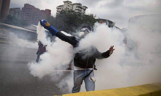 Demonstrators clash with the riot police during a protest against Venezuelan President Nicolas Madur