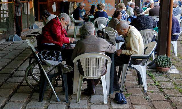 Elderly people play cards in Rome