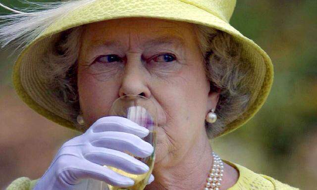 Britain´s Queen Elizabeth II takes a sip of wine with during a wine country tour in Barossa Valley n..