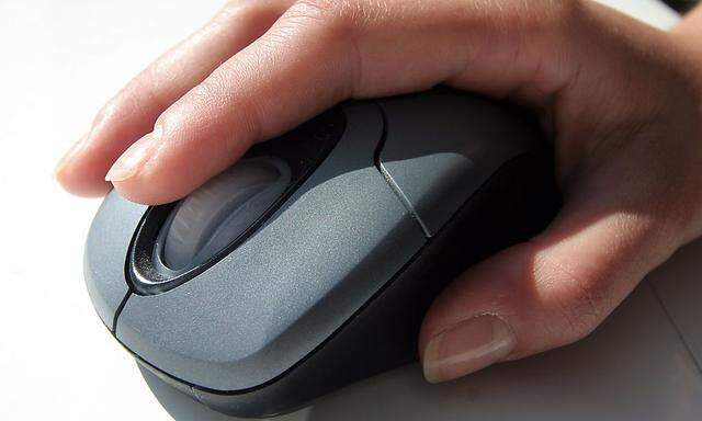 A generic picture of a woman in an office using a computer mouse.