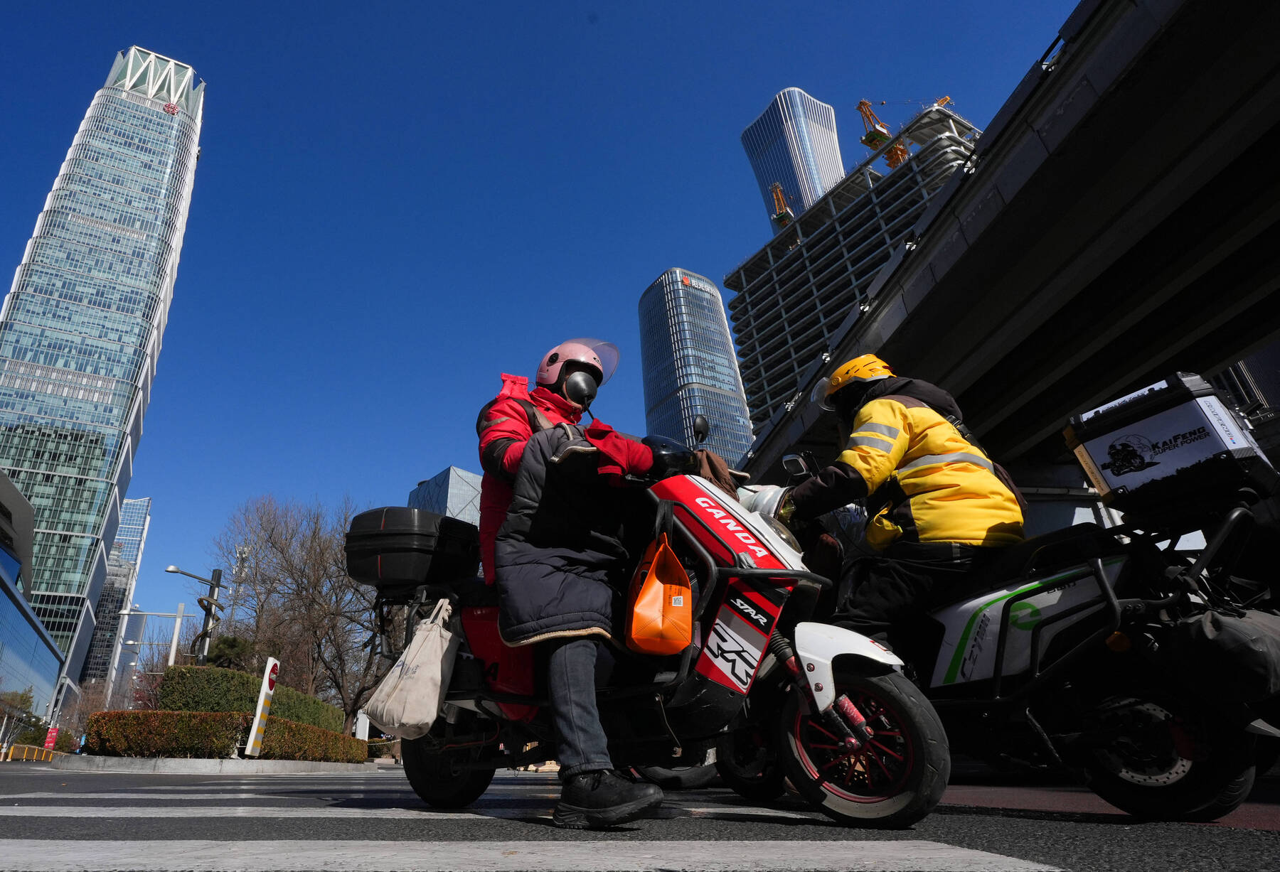 Beijing Credits Red Light Wait Times for Food Couriers to Ease Pressure