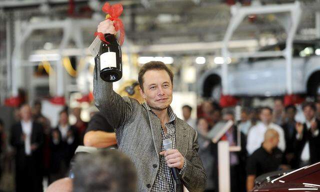 File photos of Tesla Chief Executive Officer Elon Musk celebrating at his company's factory in Fremont