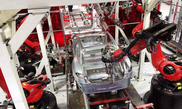 FILE PHOTO --  Tesla vehicles are being assembled by robots at Tesla Motors Inc factory in Fremont
