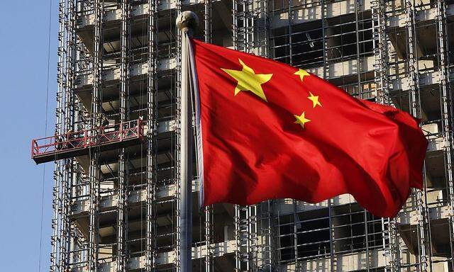 File photo of a Chinese national flag fluttering at a construction site for a new residence complex in Beijing