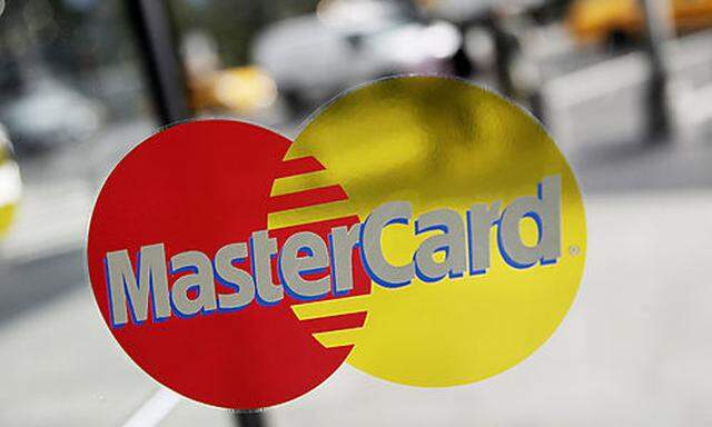 FILE- This Sept. 21, 2011, file photo. shows a MasterCard sign on a revolving door in New York. Maste