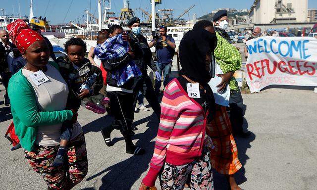 Migrants disembark from 'Vos Prudence' offshore tug supply ship as they arrive at the harbour in Naples