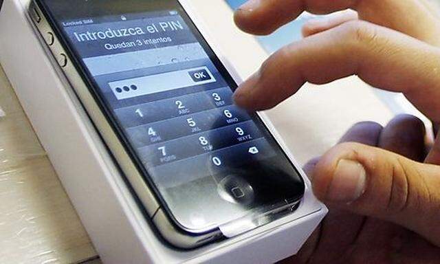 A customer assigns a PIN number to his new iPhone 4 at a Telefonica store in Madrid