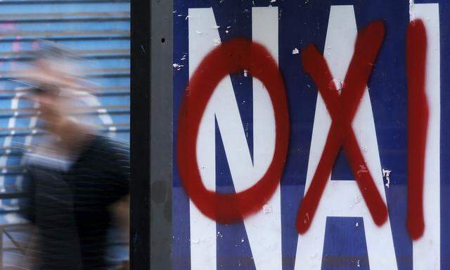 A referendum campaign poster that reads 'Yes (Nai)' is seen on a bus stop with a graffiti that reads 'No (Oxi)' on it in Athens