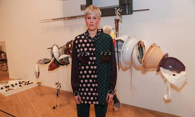 Artist Helen Marten poses for photographs with her work entitled ´Brood and Bitter Pass´ after being announced as the winner of the Turner Prize at the Tate Gallery in London