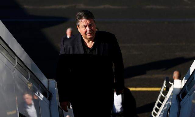 German Economy Minister Sigmar Gabriel boards a plane as he leaves for a visit to Iran, at the airport Tegel in Berlin