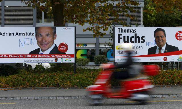 Election posters for Swiss People´s Party candidates are seen on a street in Guemligen