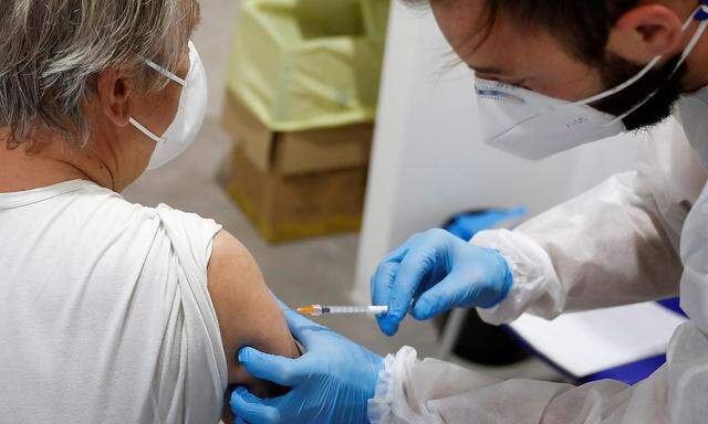 FILE PHOTO: Italians receive Moderna COVID-19 vaccine, in Rome