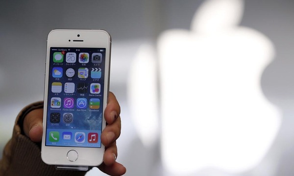 File photo of a woman holding her new Apple iPhone 5S after buying it at an Apple Store at Tokyo´s Ginza shopping district