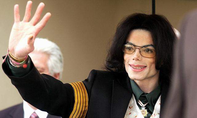 Michael Jackson gestures to fans as he leaves the court on the third day of his child molestation tr..