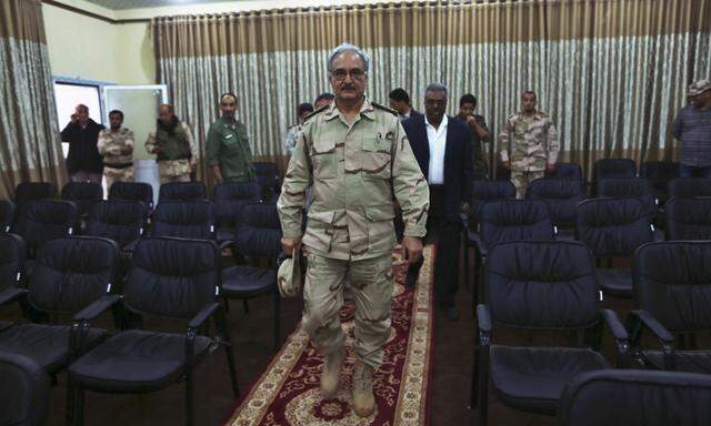 General Khalifa Haftar walks to a news conference in Abyar