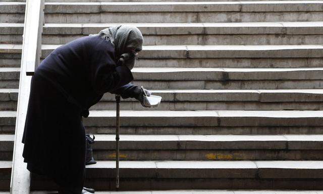 A beggar stands in an underground walkway in Moscow