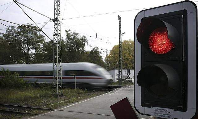 File photo of  ICE high speed train of  Deutsche Bahn speeding past red light outside the main train station of Hanau