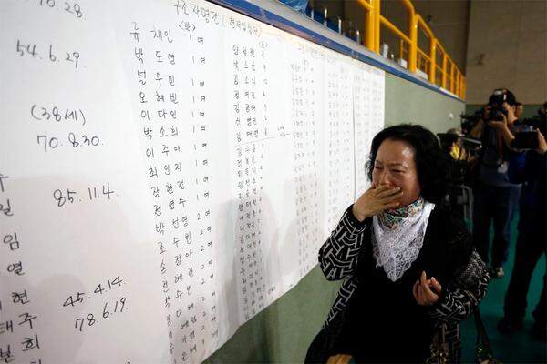 Eine Frau findet den Namen ihres Sohnes auf der Liste jener Passagiere, die gerettet wurden.
