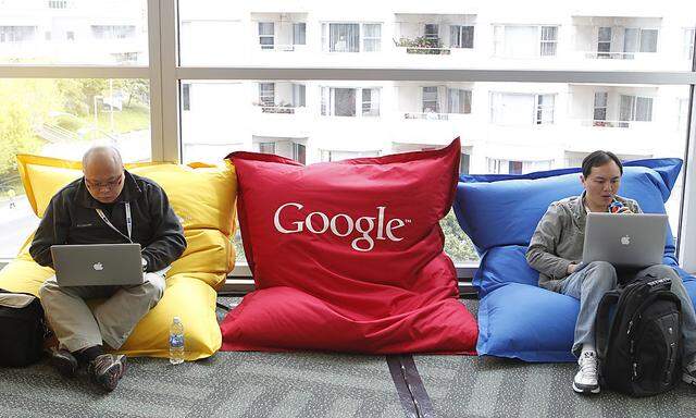 Attendees Dominie Liang and Ruslan Belkin utilize the common area at the Google I/O Developers Conference in the Moscone Center in San Francisco