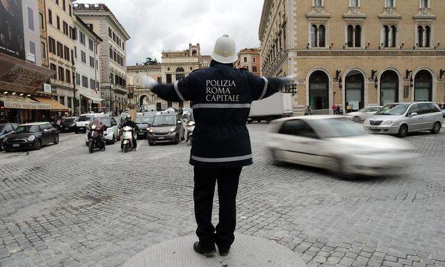 Policeman gestures as he directs traffic in downtown Rome