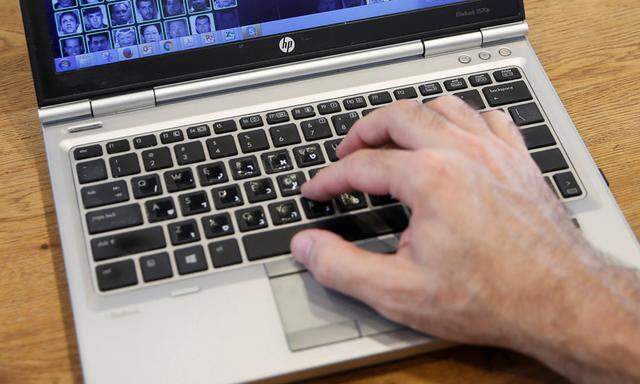 An employee uses a laptop to demonstrate how Israeli start-up Faception works during an interview with Reuters in Tel Aviv, Israel