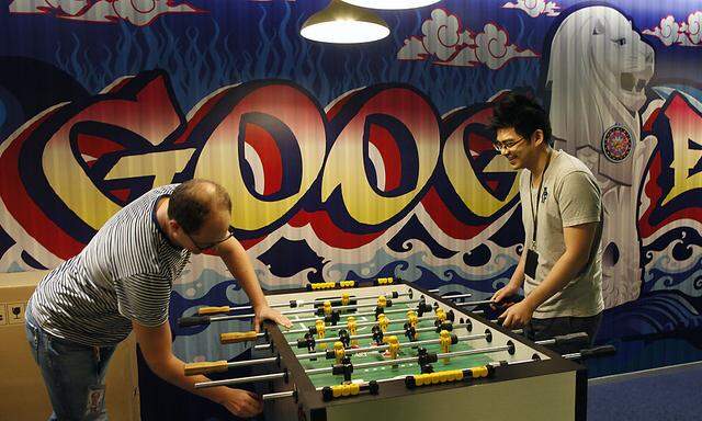 Google´s communications manager Moroney plays table soccer with a Google employee at a recreational area of their Singapore office