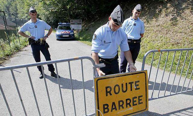 French gendarmes block access to a road to La Combe d'Ire in Chevaline