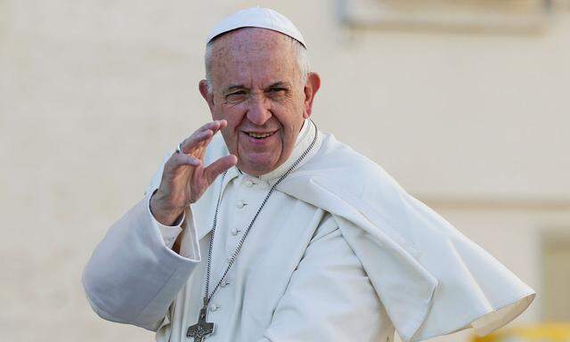 Pope Francis waves as he arrives to lead the general audience in Saint Peter's Square at the Vatican 