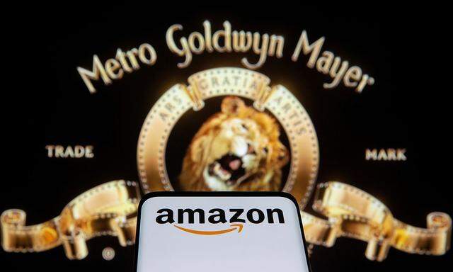 FILE PHOTO: Smartphone with Amazon logo is seen in front of displayed MGM logo in this illustration taken