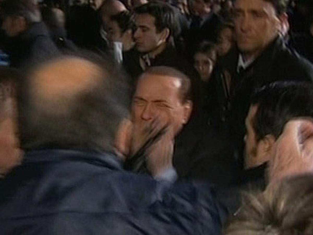 Angriff auf Italiens Premier Silvio Berlusconi: Nach einer Parteirede in Mailand schleudert ein Mann dem Ministerpräsidenten eine Miniatur des Mailänder Doms ins Gesicht.