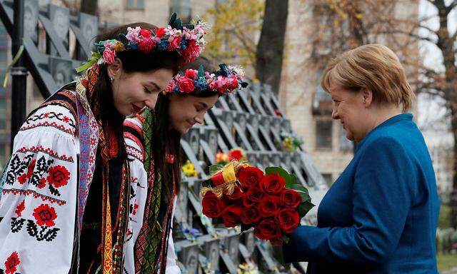 German Chancellor Merkel lays flowers at a monument commemorating the so-called 'Heavenly Hundred' in Kiev