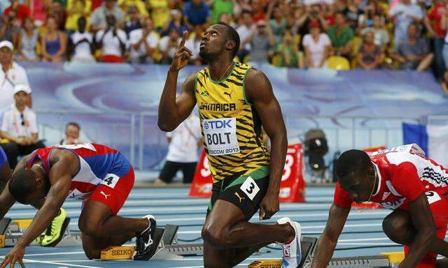 Bolt points upwards before a false start in their men's 100 metres heats during the IAAF World Athletics Championships in Moscow 