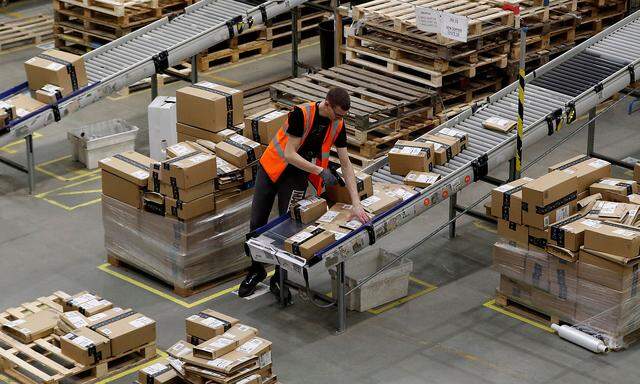 FILE PHOTO: A worker sorts parcels at Amazon's fulfilment centre in Peterborough