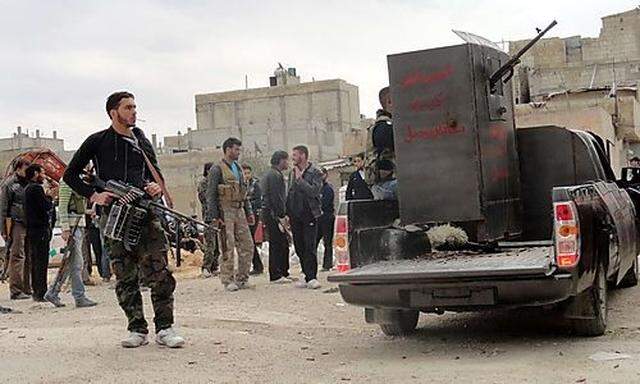 Members of Free Syrian Army are seen deployed in al-Bayada, Homs