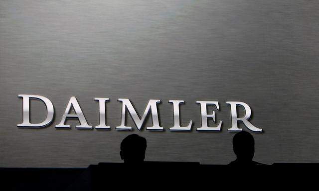 Daimler board members sit on the podium during the company's annual news conference in Stuttgart