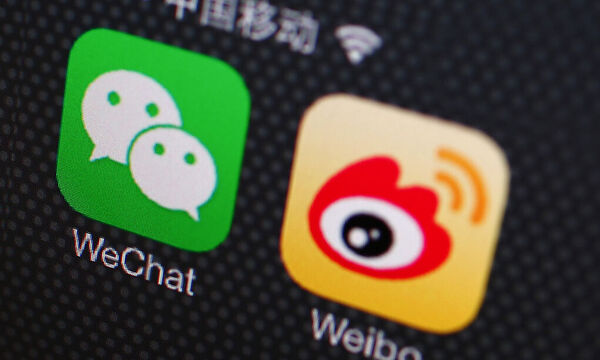 A picture illustration shows icons of WeChat and Weibo app in Beijing