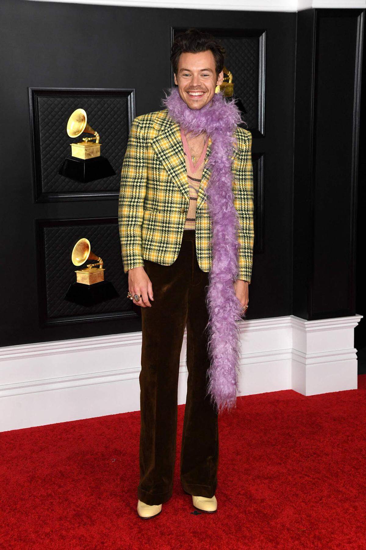 Wie auch schon bei den Golden Globes handelte es sich bei den 63. Grammy Awards um ein Hybridmodell aus physischer und virtueller Red-Carpet-Show und Preisverleihung. Während viele Nominierte zu Hause vor dem Bildschirm die Show verfolgten, waren einige Stars unter strengen Hygiene- und Sicherheitskonzepten auch im Los Angeles Convention Center anzutreffen. Und natürlich nahmen sie die Gelegenheit, sich wieder für einen richtigen Red Carpet in Schale zu werfen, wahr. So etwa Musiker Harry Styles, der mit einer violetten Boa erschien.