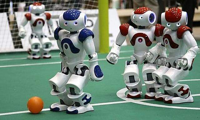 Humanoid robots compete in a soccer match the RoboCup 2009 in Graz