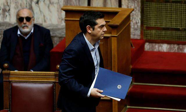 Greek PM Tsipras addresses lawmakers before an omnibus bill vote in Athens