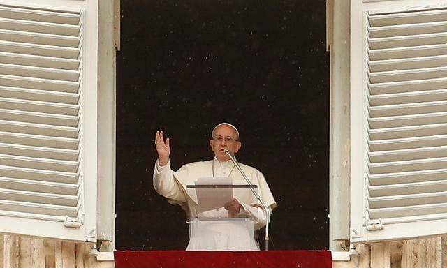 Pope Francis makes a blessing as he arrives for the Angelus prayer in Saint Peter's Square at the Vatican