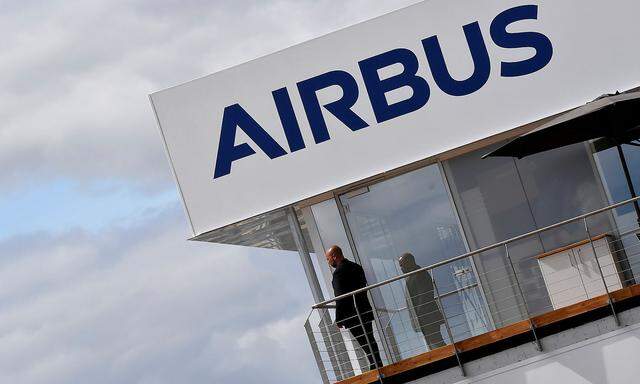 FILE PHOTO: A man stands at an Airbus trade pavilion at Farnborough International Airshow in Farnborough, Britain