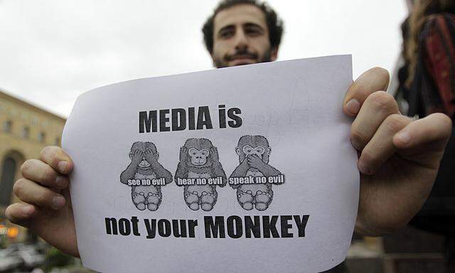 A man holds a banner during a rally to mark World Press Freedom Day in Tbilisi